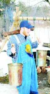 Conservation Technician Chris Bialek was demonstrating the way they used to carry sap and syrup.