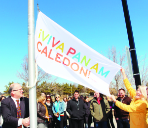 Mayor Allan Thompson was assisted by Councillor Barb Shaughnessy as he raised this flag at Town Hall last Wednesday to mark 100 days until the start of the Pan Am Games. Photo by Bill Rea