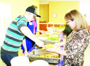 FISH FRY AT BOLTON UNITED There were lots of hungry people out last Saturday night for the annual Fish Fry at Bolton United Church. Matthew Dunn was serving former Caledon councillor Patti Foley. Photo by Bill Rea