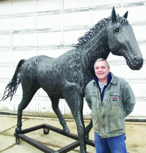 King Township's Kendall McCulloch shows off his unique metal horse sculpture that has caught the eye of the Town of Caledon. Photo by Mark Pavilons