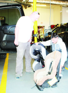 CAR SEAT CLINIC Caledon OPP Auxiliary officers recently held the latest of their child car seat clinics at the Bolton Fire Hall. York Region Auxiliary Constable Trevor Pirri was explaining some of the adjustment requirements to Shane Miller of Bolton. The next clinic is scheduled for May 26 from 6:30 to 8:30 p.m. at the fire hall at 28 Ann St. in Bolton. It will be by-appointment only. Call 905-584-2241 for more information or to book an appointment. Photo by Bill Rea