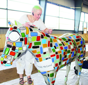 Melinda McArthur of Heatherlea Farm Shoppe on Winston Churchill Boulevard, near Belfountain, was the subject of one of the posters promoting the new brand. There are 26 horses being decorated at the Equestrian Park in anticipation of the coming Games. Wendy McLeod of Caledon East called this design Banburys Cross. It contains pixels broken down with words in them.