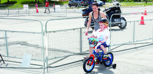 Lea McKinley of Orangeville was helping her son Brayden, 3, navigate the bike track.