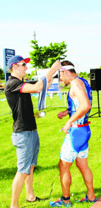 Pan Am athlete Andrew Yorke greeted Sean Bechtel after he completed a 400-metre swim, 15-kilometre bike ride and five-kilometre run.