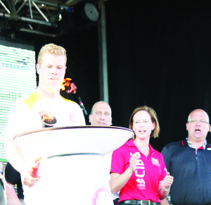 The high point of Caledon Day came when Toronto Maple Leaf forward Peter Holland used the Pan Am Torch to light this cauldron on the stage in Caledon East. Photo by Jake Courtepatte