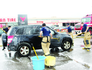 FIREFIGHTERS WASHING CARS Local firefighters were busy Saturday at the parking lot of the Canadian Tire store in Bolton. Caledon Fire and Emergency Services were holding their 10th annual Car Wash in support of Muscular Dystrophy Canada. Photo by Bill Rea