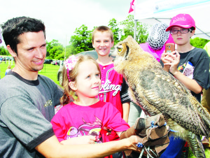 People got the chance to learn something about birds of prey from King Sport Environmental and Falconry in Caledon East. Adam Geddes of Brampton watched as his children Hailey, 5, Jacob, 9, and Noah, 11, got to meet this three-month-old great horned owl, named Edwinia.