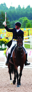 Chris von Martels, aboard Zilverstar, acknowledged the cheers from the crowd after his individual performance in dressage Tuesday. It put him in first place, but this was before his American rivals Steffen Peters and Laura Graves took to the ring. Photo by Bill Rea