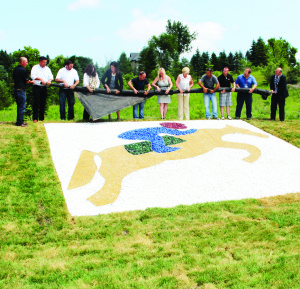 GRAVEL GARDEN UNVEILED The Town of Caledon officially unveiled a spectacular gravel garden on the northeast corner of Old Church Road and Highway 50 last Wednesday. The garden depicts the jumping horse, Caledon's official icon of the Pan Am Games, and will serve as a reminder of the summer of 2015 for years to come. “It's another proud Caledon moment today as we unveil this gravel garden,” said Mayor Allan Thompson (far right). “It is through the relationships with Caledon that this became a reality. Thank you to the businesses who stepped up to create this lasting legacy.” Cornerstone Landscaping, Marrex Construction and Excavating Ltd., Sunshine Design and Construction Ltd. and Verti-crete of Bolton played instrumental roles in transforming this quiet corner into a Games' legacy. Photo by Bill Rea