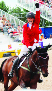 Canadian Jessica Phoenix celebrated Sunday after turning in a faultless round of show jumping in the eventing competition. She took the individual silver medal in the class. Photo by Bill Rea