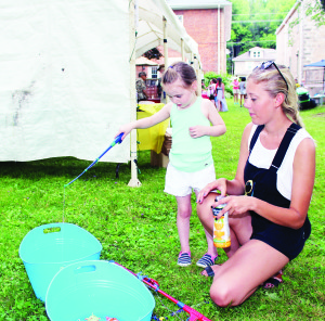 There were games for the younger folks to try. Miah Kortekaas of Cheltenham watched as Quinn Travers, 4, of Belfountain tried her luck at fishpond.