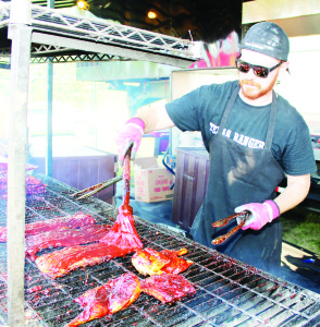 Paul Antaya of Niagara Falls was applying lots of sauce on the ribs for Texas Rangers.