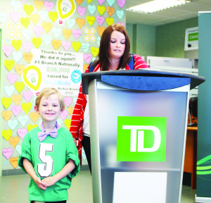 Ashley Bernier addressed the audience, accompanied by her six-year-old son Hartley, a SickKids patient ambassador.