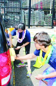 The teens taking part in the Youth Leadership Camp held a car wash at Home Depot in Bolton, with proceeds going toward Shop With a Cop. Jake Mihkelson of Belfountain and Rushali Shah of Caledon East were busy cleaning this car.