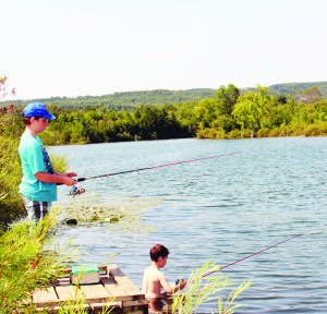 GETTING THE HANG OF FISHING The Ontario Federation of Anglers and Hunters brought their Travelling TackleShare to the area over the weekend, stopping at the Ken Whillans Resource Management Area on Highway 10 Sunday. It was an opportunity for aspiring anglers to give it a try. Jacob and Lucas Wilson of Brampton were among those trying their luck. Photo by Bill Rea