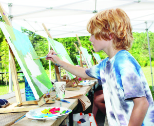 ART IN PARK There were a number of artists gathered recently at Terra Cotta Conservation Area to take part in the Art in the Park event. Steven Ramer-Clark, 8, of Orangeville was among them, working on this acrylic creation. Photo by Bill Rea