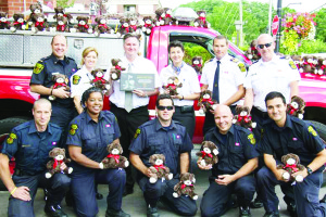 TIM HORTONS DONATES TIM TEDDIES Brad and Liz Stafford, (back row, third and fourth from right) of Bolton Tim Hortons, donated a truck load of Tim Teddies to the Caledon Fire and Emergency Services. Deputy Chief of Operations Darryl Bailey (back row, second from right), Fire Prevention Officer Gillian Boyd (back row, second from left), District Chief Colin Hanna (back row, far right), as well as volunteer and full time personnel from the Bolton station happily received the donation. The Staffords also received a Partners in Fire Safety plaque from the department for their ongoing support in station events, including the annual Station 302 Fire Prevention Open House, hosting the Midnight Madness Caledon Community Safety Courtyard and supporting station fundraising events. Caledon Fire and Emergency Services responded to 2,252 incidents last year with many of those calls involving children. The Tim Teddies are a welcomed donation as they are given to comfort children involved in a traumatic situation. Photo courtesy of the Town of Caledon