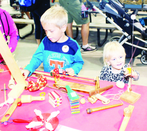 Matthew and Eden Kurz of Southfields Village were pretty impressed with some of the old-fashion toys being shown by Old Britannia Schoolhouse.