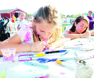 There were crafts to be done at the Elephant Thoughts booth. Kate Delaney, 7, of Palgrave and her mother Kayla Cameron were working on their creations.