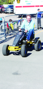 The peddle cars were fun to drive around the track, as Jeff Enns learned.