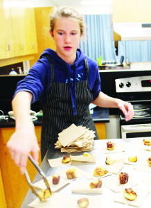 Student Lexi Bartello was serving up mini cinnamon buns in the family studies area of the school.