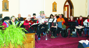 CAROLLERS PERFORM AT CLAUDE CHURCH A variety of seasonal music was on the program last Sunday at Claude Presbyterian Church on Highway 10. The Orange Peel Carollers were putting on the concert.       Photo by Bill Rea