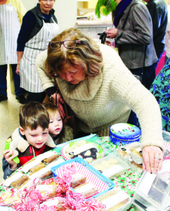 BAZAAR RAISES FUNDS FOR HOSPICE There was lots of merchandise but very little elbow room recently as crowds packed the Inglewood Community Centre for a bazaar held in support of Bethell Hospice. Roxanne Mountain of Inglewood was pointing out some of the goodies for sale to her grandchildren, Trent and Alexandria Salisbury, 4 and 2, of Alton. Photos by Bill Rea