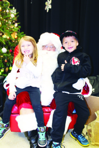 About the only thing that was lacking recently at St. Cornelius Elementary School in Caledon East was elbow room. The halls and gym were packed with tables manned by vendors and patrons looking for items of interest at the Christmas Market Place. Santa Claus was popular, and lots of youngsters were anxious to meet him, including Abigail Hedges, 4, and her brother Rowan, 7, of Caledon East. Photos by Bill Rea