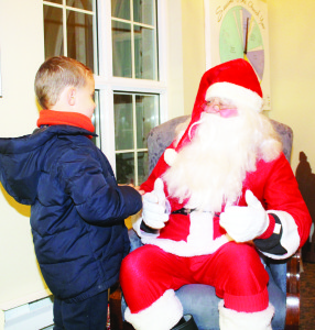 Knox United Church hosted festivities after the parade and tree lighting. Santa took some time to talk to his many friends, like Luc Turgeon, 4, of Forks of the Credit.