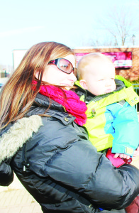 Amber Gallaugher from Mulmur brought her 10-month-old son Grady to get a good look at Santa Claus as he rode by.