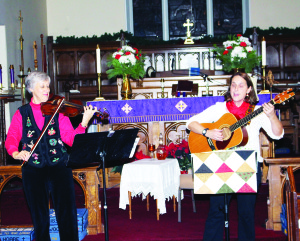 Felicia Urbanski and Elswyth Fryer provided the accompaniment for the carol singing Monday night.