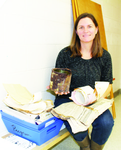 James Bolton teacher Marny Bissonnette holds some of the items buried in the time capsule in 1971.