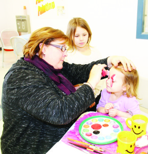 Lynn Howard was busy painting the faces of lots of youngsters, including Councillor Jennifer Innis's two daughters Jolee and Lyra Pallister. Photos by Bill Rea