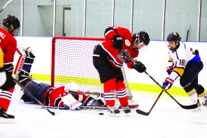 Caledon's John Cyfko just misses a wraparound attempt on Orillia goaltender Gordie Weiss. The Golden Hawks shut out the Terriers 2-0 at Caledon East Sunday. Photo by Jake Courtepatte