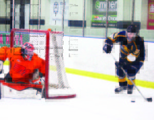 Daniel Cafagna looks to make a pass out front of the Flyers' net in Midland on Friday. Photo by Jake Courtepatte