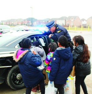Youngsters crammed lots of cruisers Caledon OPP officers spent several days leading up to the holidays visiting local schools so students could cram cruisers with contributions to the Caledon Community Services Santa Fund. The effort collected 6,650 pounds of canned goods, toiletries and more than $1,000 worth of toys. Sergeant Mike Mobbs was supervising the cramming of this cruiser at SouthFields Village Public School. Constables Kevin Johnston and Brenda Evans, Sergeant Marcus Sanders, teacher Jennifer Caruk, Principal Andrew Greenhow and Constable Greg Page helped these students at Ellwood Memorial Public School. Photos by Bill Rea