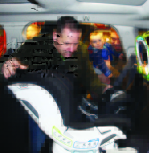 CAR SEAT CLINIC IN BOLTON Caledon OPP Auxiliary officers recently held one of their regular child car seat clinics at the Fire Hall in Bolton. Aux. Constable Ed Hickey was adjusting this seat while SouthFields Village resident Sam Hattar and his 11-month-old son Jack watched. The next clinic is scheduled for Feb. 23 from 6:30 to 8:30 p.m. at the fire hall at 28 Ann St. in Bolton. It will be by-appointment only. Call 905-584-2241 for more information or to book an appointment. Photo by Bill Rea
