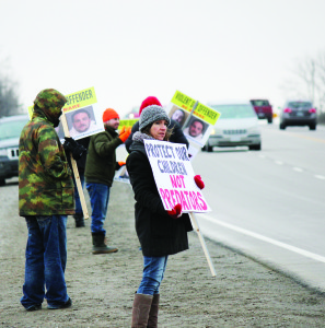 Around a dozen concerned parents and Schomberg residents protested in front of the supposed residence of convicted sex offender Keith Constantin Saturday. The protesters say it won't be the last. Photo by Jake Courtepatte