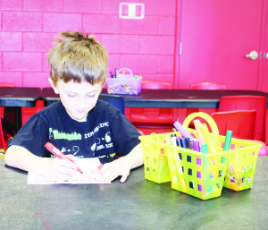 There were crafts to work on at CCRW, and Jayden Cowan-Rowe, 6, of Bolton was working on his.