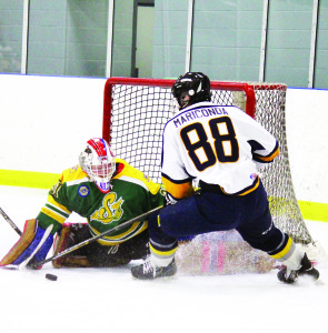 Caledon's Christian Mariconda tries to stuff the puck past Stayner goaltender Luke Aulthouse in game four of the best-of-seven GMOHL series. The Golden Hawks won the series 4-2. Photo by Jake Courtepatte
