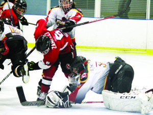 Matthew Zanelli gets knocked down in front of the Centre Wellington crease in Fergus Monday night. The Hawks fell to the Fusion in overtime of the deciding game of the OMHA semifinals. Photo by Jake Courtepatte