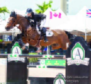 Tiffany Foster and Victor sail over the Artisan Farms signature fence on their way to victory in the $35,000 Ruby et Violette WEF Challenge Cup Round XII held March 31 at the Winter Equestrian Festival in Wellington, Florida. Photo by Starting Gate Communications