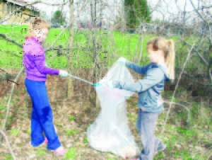 CLEANING UP FOR SPRINGLEWOOD The community was out Sunday morning for Springlewood. It saw people making their way through Inglewood doing a spring clean-up of the area. Mia Vanden Hoek, 10, and her sister Lily, 8, were finding lots of litter in the are of the Inglewood Community Centre. Photo by Bill Rea
