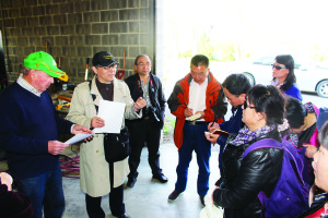 Tom Dobson (left), with Anning Ding translating, explained details on his King City area operation to visitors from Soun College. Photo by Bill Rea