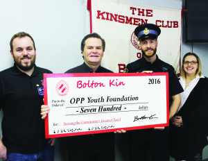 KIN SUPPORTS LEADERSHIP CAMP Two local young people will be spending time this August at the youth Leadership Camp of Canada, under the auspices of OPP. The Bolton Kinsmen recently made a contribution to that effort, to the tune of $700. Club President Paul McLoughlin and Treasurer Robert Ward recently made the presentation to Constable Robert Bucsis and Constable Tamara Schubert of Caledon OPP.        Photo by Bill Rea