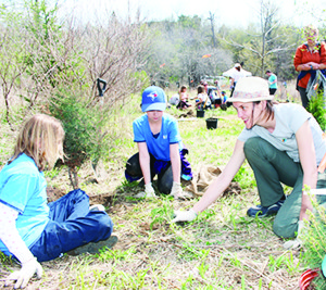 Ashley Ventura and Jorja Stevens of the 101st Brampton Girl Guides were getting some planting pointers from Diana Wilson of TRCA. Photos by Bill Rea