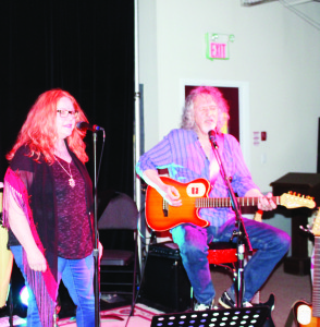 HENMAN PERFORMS AT CROSSCURRENTS David Henman, a founding member of April Wine, had a packed house to perform for recently at CrossCurrents Cafe in Bolton. He is seen here performing with Rosemarie Bell. Photo by Bill Rea