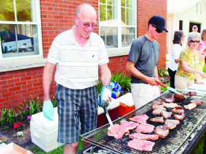 STEAK BARBECUE AT CHURCH There was a lot of smoke in the air, but also the smell of sizzling steaks Friday night as Caledon East United Church hosted its annual Steak Barbecue for the community. The father and son team of Barry and William Kozluk were hard a work at the grill, keeping up with the demand from the hungry diners. Photo by Bill Rea