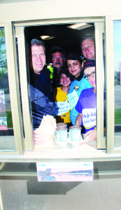HELPING KIDS GO TO CAMP Tim Hortons outlets held their annual Camp Day recently, raising money to send local children to camp this summer. Things were very busy at the store on Regional Road 50, south of Bolton, as representatives of Caledon Fire and Emergency Services were pitching in on the effort. Captain Don Rea and Firefighters Tom Blumetti and Darryl Thompson were working with Sheena Cayapat, Kanwal Virk and Marvic Attard. Photo by Bill Rea