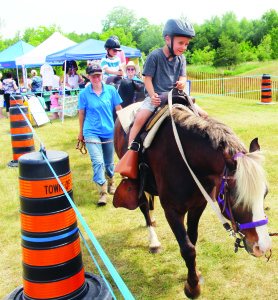 Representatives of Teen Ranch were on hand with some of their horses, offering rides. Henry and Thomas Hurley, 5, of Caledon East were among those getting into the saddles.